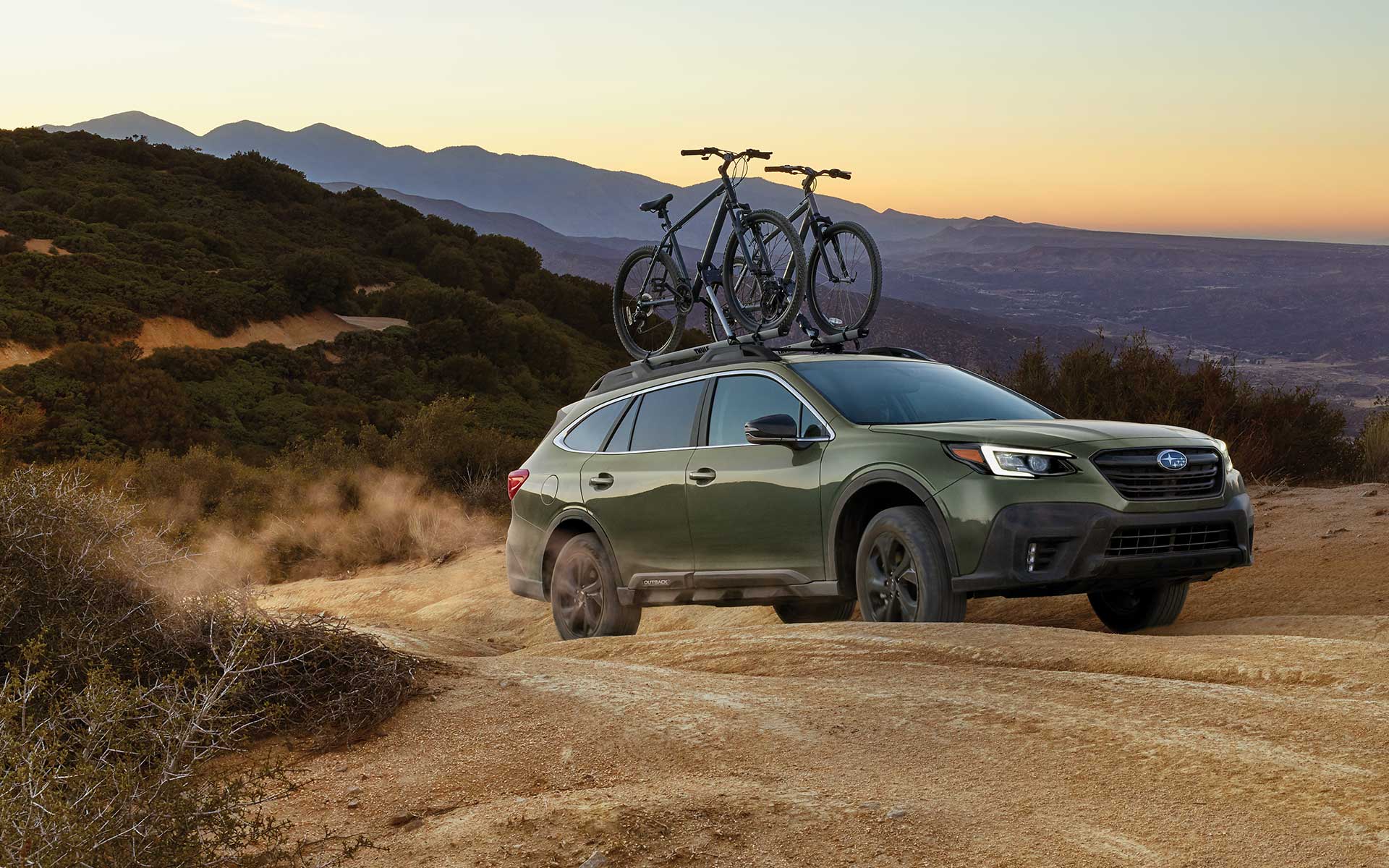 A 2022 Subaru Onyx Edition XT driving on a dirt road in the mountains.